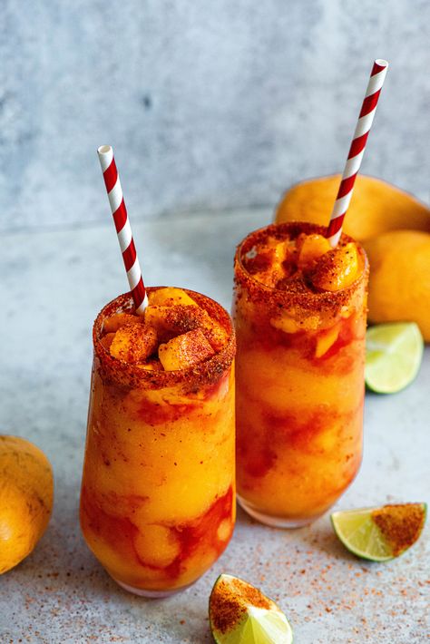 Mangonadas, also called chamangos, are a frozen mango pulp, mixed in with sweet, spicy and tangy chamoy — a sauce made with tamarind and plum. The sauce is sweetened and also spiced up with chile powder. The combination of flavors is heavenly. Topped with chile lime salt, lime juice and chunks of mango. @imperialsugar Frozen Mango Smoothie, Peach Bellini Recipe, Mango Chile, Spicy Fruit, Fruit Topping, Bellini Recipe, Mango Smoothie Recipes, Mango Drinks, Chile Sauce