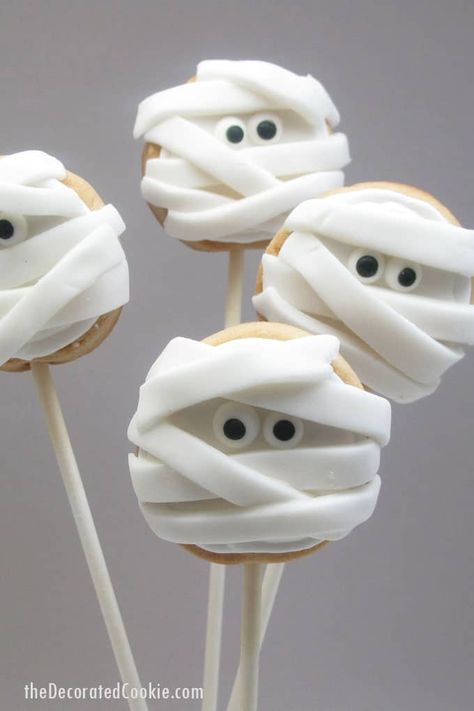 Halloween mummy cookies on a stick -- fun food idea for Halloween Halloween Mummy Cookies, Halloween Food Snacks, Biscuits Halloween, Mummy Cookies, Spider Cupcakes, Easy Halloween Snacks, Fun Halloween Treats, Cookie Sticks, Halloween Sugar Cookies