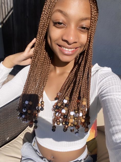 Short Brown Knotless Braids With Beads, Brown Braids With Brown Beads, Ginger Twist With Beads, Brown Braids For Black Women With Beads, Brown Fulani Braids With Beads, Long Brown Braids With Beads, Light Brown Braids With Beads, Black And Brown Braids With Beads, Brown Short Braids With Beads