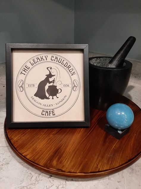 Perfect addition to your Harry Potter themed coffee bar! Square black wood composit and glass frame with optional flip out stand. 7x7 in. Coffee Bar Black, Harry Potter Coffee, Leaky Cauldron, London Cafe, Coffee Bar Decor, Bar Black, Glass Frame, Book Fair, Glass Frames