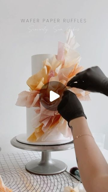 Sincerely, Sam Cakes on Instagram: "WAFER PAPER RUFFLE TIPS 👇🏼  In the first video, you will see a large portion of the cake has been covered with wafer paper (flat against the cake.) I simply use water/steam to stick. I don’t always use this method as it’s not always necessary but, when it comes to coloured wafer, the oil reduces the tackiness of the paper & it needs a little effort to stick. Method from @alcakemy   Usually, the way I shape my ruffles allows me to insert a long wire into the base. Comment ‘VIDEO’ & I will send a DM with video snippets on how to wire ruffles 💞  - Insert wires into ‘main’ ruffles (these will hold the shape of the total placement.)  - To create shape & stability, use a cake steamer. The steam will help the wafer become tacky & you can stick pieces togethe Wafer Paper Decorations, Rice Paper Decorated Cakes, Wafer Paper Cake Tutorial, Wafer Paper Cake Decoration, Cake Steamer, Wafer Paper Tutorial, Paper Ruffles, Mexican Cake, Red Birthday Cakes