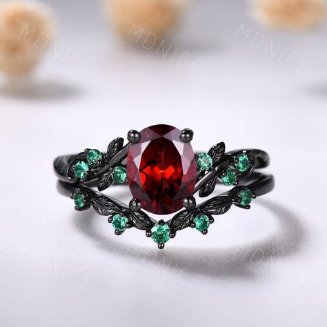 Oval cut garnet engagement ring set Gothic Black gold ring Art deco leaf emerald wedding ring nature inspired red garnet bridal promise ringt, Red Garnet Silver Ring --Engagement Ring-- Main Stone: 6x8mm oval shaped natural garnet Side stone: lab created emerald --Wedding Ring-- Stone: 0.24ct  lab created emerald Same style with moissanite side stones: https://www.etsy.com/listing/1699624485 ❤The main stone can be replaced with other natural or lab gemstones. ❤Engraving is available. ❤I can do r Red Wedding Ring, Green Wedding Rings, Romantic Theme Wedding, Dream Wedding Ring, Garnet Engagement Ring, Black Gold Ring, Emerald Wedding Rings, Emerald Wedding, Green Rings