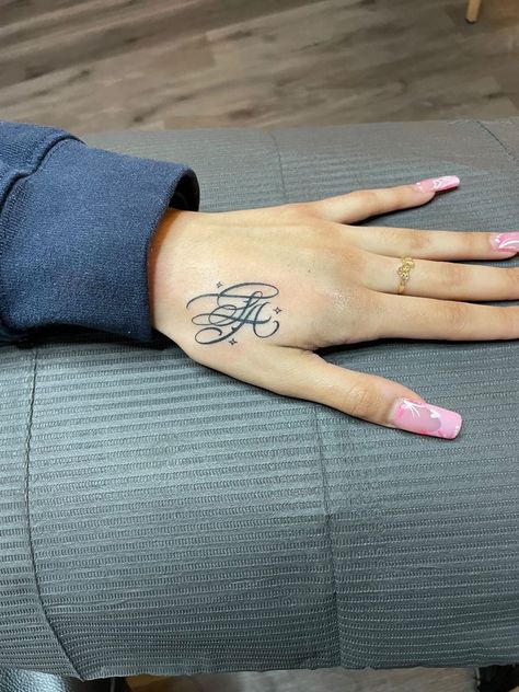 777 Hand Tattoo Name For Women, Letter Initial Tattoo Placement, Hand Tattoo Baddie, Where To Put Name Tattoos, Thumb Tattoos Side Words, K Hand Tattoo, La Hand Tattoo, Initial Tattoo Hand, Hand Initial Tattoo