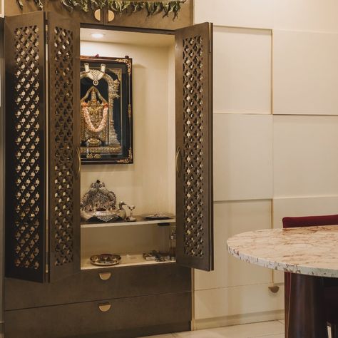 Small space mandir,dining area and crockery design! This mandir design fits perfectly in compact spaces, with a clever camouflaged cabinet that stores crockery out of sight. The folding door keeps the passage clear, and there’s even a cozy table for four. #smallspacesolutions #mandirdesign #space-saving #homedecor #interiordesign #compactliving [efficient design , small space interiors , mandir design , space saving hacks ] Compact Mandir Designs, Mandir Cabinet Design, Wardrobe With Study Table Design, Small Mandir, Table For Four, Cozy Table, Mandir Designs, Crockery Design, Study Table Designs