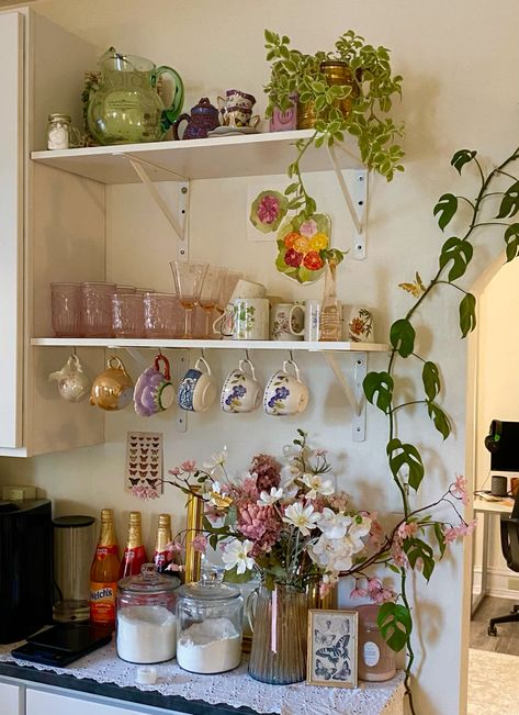 apartment kitchen aesthetic maximalist decor pretty butterfly vintage thrifted antiques mugs tea cups glasses pink coffee nook flowers indoors plants interior design Vintage Apartment Kitchen Ideas, Aesthetic Vintage Apartment, Open Apartment Kitchen, Small Girly Apartment Ideas, Floral Apartment Aesthetic, Vintage Apartment Aesthetic Kitchen, Tea Mugs Aesthetic, Thrifted Kitchen Aesthetic, Homey Apartment Aesthetic