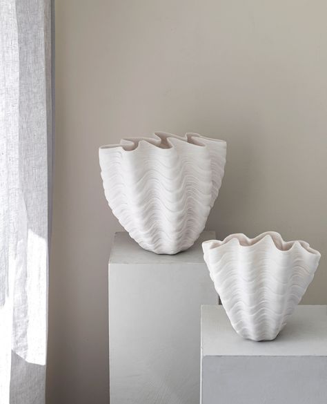 A touch of ocean tranquillity and timeless design, the SHELL vase is a true centrepiece. With its organic, seashell-inspired shape and pure white colour, it stands out as a work of art on its own or when adorned with fresh flowers or branches. The uniquely shaped opening makes styling easy, holding arrangements in place for a striking display. Whether on a coffee table or windowsill, the SHELL vase brings a sense of calm and natural beauty into any space. Available in two sizes. Soap Dispenser Tray, Shell Vase, Minimalist Vase, Placemats Kids, Kitchen Roll Holder, Bedroom Cushions, Vase White, Beach Theme Decor, Large Stone