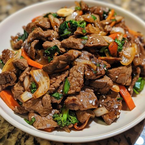 🔥🍖 Experience the thrill of Mongolian BBQ at home! Easy, customizable, and delicious. #MongolianBBQNight Mongolian BBQ Ingredients: Beef strips (1 lb) Soy sauce (1/4 cup) Brown sugar (2 tbsp) Garlic, minced (1 tsp) Ginger, minced (1 tsp) Vegetables (mixed, 2 cups) Cooking oil (2 tbsp) Instructions: Marinate beef in soy sauce, sugar, garlic, and ginger. Heat oil, stir-fry beef until browned. Add vegetables, cook until tender. Serve hot with rice or noodles. 🔥🍲 Sizzle up your dinner with this... Mongolian Bbq At Home, Bbq At Home, Mongolian Bbq, Garlic And Ginger, Instagram Recipes, Beef Strips, Twisted Recipes, Marinated Beef, Fried Beef