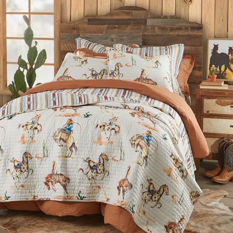 PRICES MAY VARY. ROD’S BRONCO VINTAGE WESTERN COWBOY QUILT: A timeless design that pays homage to the adventurous spirit of the frontier, this quilt pattern is inspired by the iconic bronco-riding cowboys of yesteryear. The pattern is enhanced by western motifs such as desert cacti in rustic hues of tan, rust, blue, and green. This reversible quilt features a vertical geometric striped pattern of crimson, gold, navy, and light blue on a warm, cream base. SOFT AND COMFORTABLE LUXURY: Made from 10 Western Bedding Sets Modern, Cowboy Bedding Sets, Cowboy Bedding Western Theme, Wyoming Bed Size, Cowboy Western Bedding, Kids Bedding Sets Farmhouse, Cowboy Bunk Beds, Cowboy Room, Western Quilts