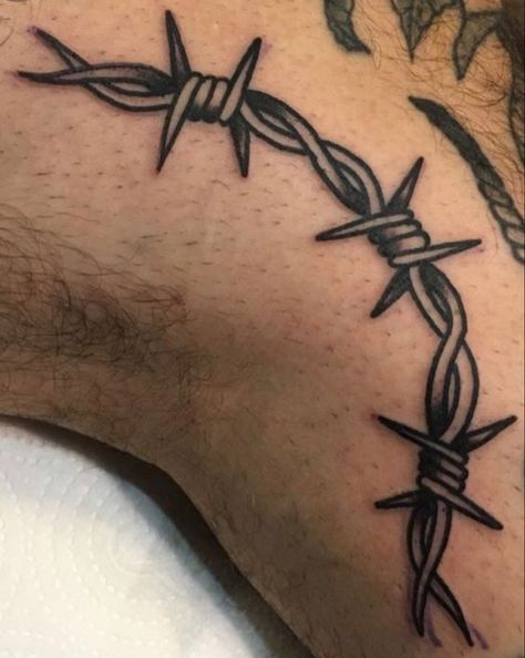 Learn the surprising barbed wire tattoo meaning before you get it on a body. As a bonus, we've added more than 60 unusual ideas for inspiration. Barbwire Tattoo, Barbed Wire Tattoo, Wire Tattoo, Barbed Wire Tattoos, Chain Tattoo, Tattoo Filler, Tattoo Meanings, Sharpie Tattoos, Knee Tattoo