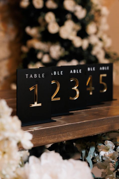 Present your seating arrangements in style with 3D Gold Mirror Acrylic Wedding table numbers.  This stylish accessory in mate black color offers a tasteful blend of function and design, adding a dash of elegance to your wedding table decorations. *Premium Quality *3D Mirror Gold Numbers *Consistent Aesthetics *Matching Set and Flower Collection Size: 5" x 7" (13 x 18 cm) COORDINATE YOUR DECOR -------------------------------- Matching flower centerpieces collection. Each table number comes with a Black And Green Wedding Decorations, Black And Gold Theme Centerpieces, Black N Gold Wedding, Black And Gold Wedding Theme Receptions, Black White And Gold Wedding Table Decor, Black And Gold Wedding Theme Decorations, Wedding Black And Gold, White Black And Gold Wedding, Black White And Gold Wedding Decor