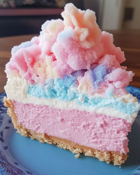 Cotton Candy Cheesecake 🍭 Ingredients: - 2 cups graham cracker crumbs - 1/2 cup melted butter - 3 packages (8 oz each) cream cheese, softened - 1 cup granulated sugar - 1 tsp vanilla extract - 1 1/2 cups heavy whipping cream - 2-3 drops pink and blue food coloring - Cotton candy (for topping) Instructions: 1. In a bowl, mix graham cracker crumbs and melted butter until combined. Press the mixture into the bottom of a 9-inch springform pan. Chill in the fridge while preparing the fill... Cotton Candy Donut, Cotton Candy Cheesecake, Blue Food Coloring, Donut Shop, Creamy Desserts, Graham Cracker Crumbs, Sugar And Spice, Beautiful Food, Cotton Candy