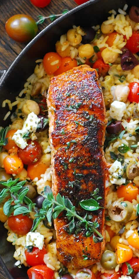 Mediterranean Salmon & Rice with Chickpeas, Cherry Tomatoes, Olives, Lemon, Oregano, and Feta Cheese - in a cast iron skillet. Mediterranean Recipes Salmon, Mediterranean Dinner Party Recipes, Dinners With Couscous, Fish With Rice Recipes, Tomato Salmon Recipes, Mediterranean Diet Recipes With Salmon, Salmon And Tomato Recipes, Summer Dinner Recipes Fish, Mediterranean Recipes Fish