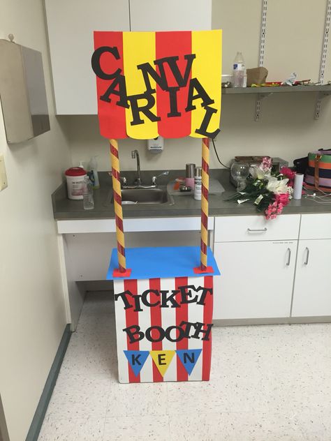 DIY Carnival themed ticket booth...this ticket booth was super easy to make all you need is a box(your choice in height) two rolls of red wrapping paper, a small piece of cardboard for the carnival sign, blue white red and yellow poster board, yellow streamer, and black paper for the letters..all items can be purchased from the dollar store! Ticket Booth Diy, Cardboard Boxes Ideas, Easy Carnival Games, Carnival Games Diy, Carnival Ticket Booth, Carnival Diy, Diy Karneval, Carnival Ticket, Diy Carnival Games