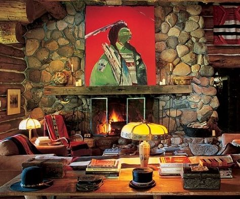 The living room of the fourbedroom primary structure. Pieces from the Ralph Lauren Home collection, such as the suede sofa and club chair, fill the compound’s interiors. A work by Fritz Scholder is above the fireplace. The cowboy hat on the table in the foreground once belonged to John Wayne. Ralph Lauren Cabin, Ralph Lauren House, Land Ideas, Colorado Ranch, Double Rl, Designer Ralph Lauren, Cabin Interiors, Colorado Homes, Ralph Lauren Style