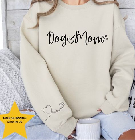 "Dog Mom Sweatshirt, Sleeve Print Dog Names, Personalized Dog Mom sweatshirt, Personalized Dog Mom Shirt, Dog mom personalized gift, Dog Mom Personalized shirt, Dog Mama Sweatshirt, Paw with Heart, Dog Lover Sweatshirt, Dog Mom Sweatshirt, Gift for Mom, Dog lover gift idea. Custom dog mom sweatshirt, personalized gift, dog mom shirt, personalized mama shirt.  HIGH QUALITY GILDAN SWEATSHIRT  1- Select your size 2- Select your color 3- Select the Quantity 4- Add your pets names to the personalization box 5- Click \"Add to cart\" button Note: For multiple items go back to the listing and repeat the steps above SIZE AND COLORS: * Unisex Sizing * Tear away label * Soft & Stylish * Retail fit PROCESSING TIME: The standard processing time is 1-3 business days. (We usually process and ship out the Dog Lover Sweatshirt, Dog Mom Tee, Dog Mom Sweatshirt, Womens Sweatshirts, Mommy Shirts, Lover Sweatshirt, Fur Mama, Mama Tee, Dog Mom Shirt