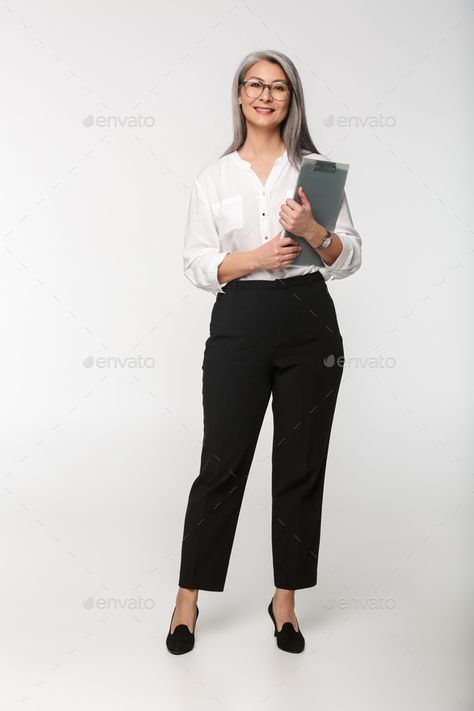 Image of adult mature woman wearing office clothes holding clipboard by vadymvdrobot. Image of adult mature woman wearing eyeglasses and office clothes holding clipboard isolated over white background #Sponsored #wearing, #office, #clothes, #woman Someone Holding A Clipboard, Person Holding Clipboard Reference, Holding A Clipboard Pose, Holding Clipboard Reference, Office Pose Reference, Business Woman Pose, Office Poses, Female Office Wear, Holding Clipboard