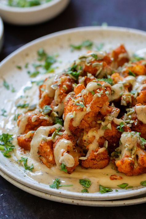 Harissa cauliflower over creamy hummus and drizzled with sweet-and-savory tahini dressing is a show-stopping entree. You can adjust the heat to suit your tastes, so don’t worry if spicy food isn’t your thing. Harissa Cauliflower, Gluten Free Pita, Creamy Hummus, Dill Dressing, Spicy Cauliflower, Gluten Free Tortillas, Tahini Dressing, Spicy Food, Vegan Eats