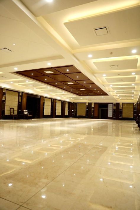 Here's a sophisticated and lively banquet hall designed with brown and gold color tones for all your celebrations. #banquet #events #dinner #venue #varanasi Banquet Hall Flooring Design, Marriage Hall Interior Design, Banquet Hall False Ceiling Design, Wedding Hall Ceiling Design, Banquet Ceiling Design, Function Hall Interior Design, Banquet Hall Ceiling Design, Party Hall Interior Design, Marriage Hall Design