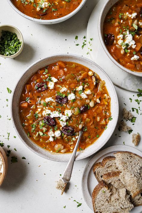 Fasolada, the iconic Greek White Bean Soup is a humble bean and vegetable soup, which is elevated with a bright acidic taste. The best part? It's served with Kalamata olives and feta cheese right on top. The result is a rich, hearty, perfectly balanced vegetarian soup that is on the table in just 45 minutes. Gluten-free. #wellseasonedstudio #fasolada #greeksoup #whitebeansoup #souprecipe Fasolada Soup, Greek White Bean Soup, Feta Soup, Bean And Vegetable Soup, How To Thicken Soup, Diced Carrots, Canned Beans, White Bean Soup, Low Sodium Chicken Broth