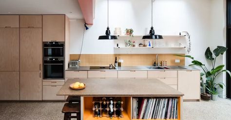 This modern and functional kitchen space features birch plywood fronts with semi-recessed grab handles. Birch plywood spacer panels sit between each IKEA unit for a bespoke plywood cabinet aesthetic. The natural tones of the birch are complemented with a stainless steel worktop. Tall units conceal a Formica Sun pantry for streamlined storage, and the island incorporates two of our Ürtil modular units, in birch and Formica Sun, stacked to create a custom shelf unit. Architect: Studio Manifest. Co Cabinet Aesthetic, Custom Shelf, Architect Studio, Ikea Units, Scandi Kitchen, Plywood Kitchen, Ikea Kitchen Island, Architectural Design Studio, Ikea Kitchen Cabinets