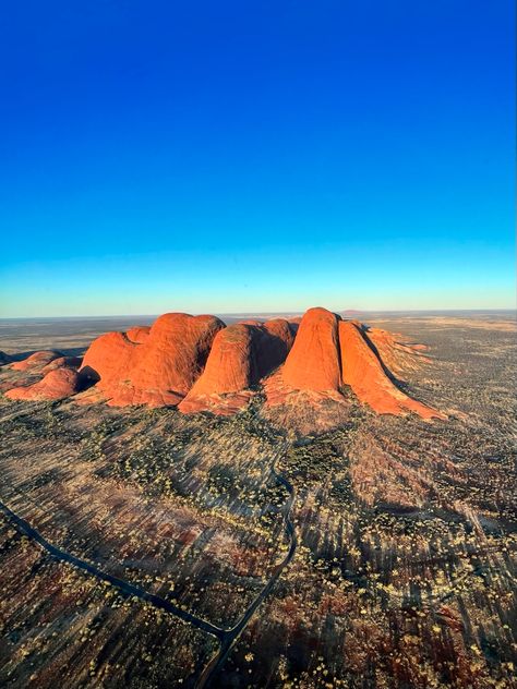 A sunset helicopter tour of Kata Tjuta with Uluru in the distance Uluru-kata Tjuta National Park, Park View, Travel Content, Helicopter Tour, Helicopter, Monument Valley, Adventure Travel, Outdoor Activities, Travel Guide