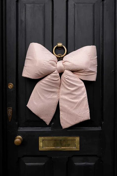 Image showing a pink bow on a black door. Unusual Christmas Decorations, Door Bow, Bow Light, Rockett St George, Pink Door, Quirky Decor, Pink Christmas Decorations, Bow Christmas, Pink Bows