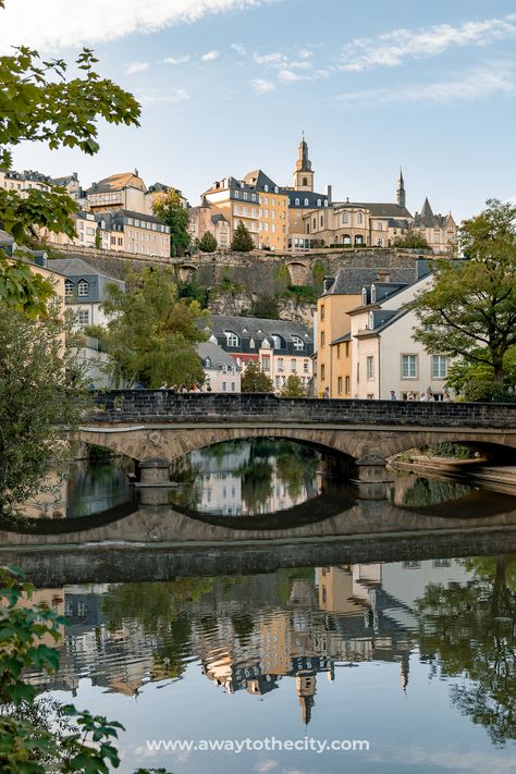 A picture of the Pont du Grund, also known as Pont du Stierchen Bridge, spanning the Alzette River in Luxembourg City's Grund District, with buildings in the background City Bucket List, Luxembourg City, Solo Trip, The Underground, Beautiful Places To Travel, City Aesthetic, City Travel, Travel Goals, Beautiful Places To Visit