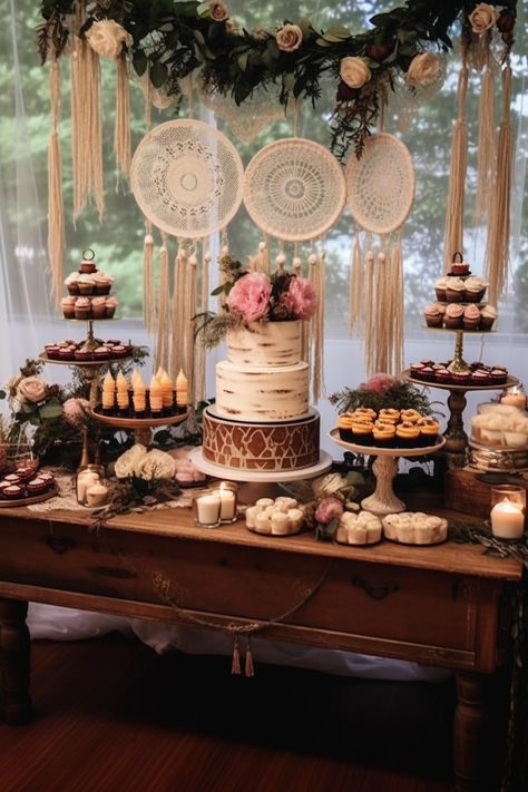 Immerse yourself in the enchanting world of a bohemian themed wedding dessert table, featuring light maroon and bronze accents. The multilayered dimensions and light pink hues create a dreamy cabincore setting. Indulge in this whimsical feast for the eyes! Bohemian Dessert Table, Boho Dessert Table, Boho Food, Table Floral Decorations, Wedding Cake Table Decorations, Dessert Display Wedding, Wedding Cake Dessert Table, Boho Backdrop, Boho Wedding Cake