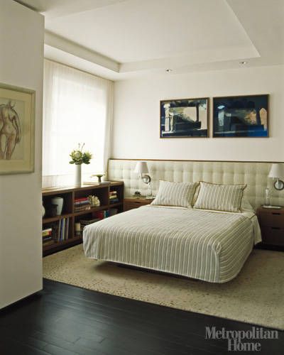 The master bedroom features walnut millwork and a room-wide upholstered headboard under art by Sarah Davis.   - ELLEDecor.com