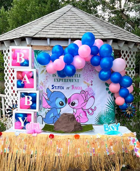 a stitch & angel themed banner is hung behind a table with a DIY volcano placed on top of it. there is a pink & blue balloon arch above the banner & on the sides of the volcano it says “boy, girl”. the table has a table skirt on it & there are boxes on the left side that say “baby”. Cartoon Themed Gender Reveal Ideas, Lilo Gender Reveal, Gender Reveal Ideas Anime, Gender Reveal Ideas Hawaiian, Stitch Themed Gender Reveal Ideas, Gender Reveal Ideas Cartoon Theme, Lilo And Angel Gender Reveal Ideas, Cartoon Theme Gender Reveal, Angel Or Stitch Gender Reveal