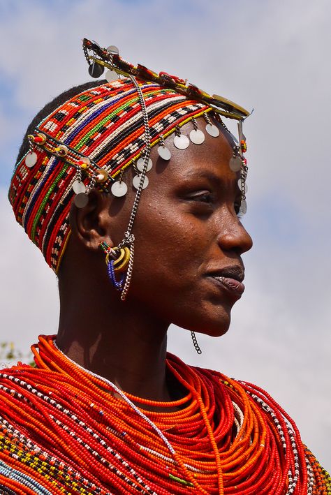 "We passed groups of Rendille heading to the market. These semi-nomadic tribal clansmen and women carried long spears, wearing brilliant red sashes decorated with silvery-coloured braids, ornaments and bangles. Tall and slender, they presented a picture-perfect image of a proud, self-assured independent people." Africa Overland; www.bradtguides.com Afrique Art, Afrikaanse Kunst, African People, Maasai, World Cultures, People Of The World, African Culture, African Beauty, Interesting Faces