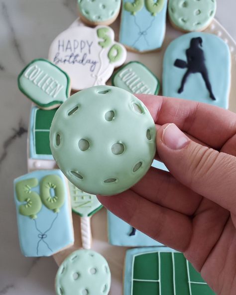 Pickleball Birthday Cookies 💙💚 Happy 50th Birthday Colleen • Decided to change my posting style a bit...I've been so busy these last 2 months, and I'm so grateful for it, but that means I can't film everything I do anymore. I'll be posting behind the scenes, though, as I go along... still have a lot to share with you 🥰 • #cookie #cookies #decoratedcookies #cookiesofinstagram #cookiehack #cookietip #cookiedecorating #satisfying #satisfyingreel #cookier #newcolors #thisweekscolors #jdsugarcooki... Pickle Ball Decorated Cookies, Pickleball Cookies Decorated, Pickleball Cupcakes, Pickleball Cookies, Pickleball Birthday, Sports Cookies, Cookie Hacks, Happy 50th, Happy 50th Birthday