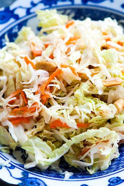 Asian Coleslaw - The defining ingredients for an Asian slaw are cabbage, rice vinegar, and toasted sesame oil. This version also has some peanut butter in the dressing and some twice toasted peanuts. Asian Coleslaw Salad, Asian Cole Slaw, Asian Slaw Dressing, Beach Cookout, Asian Coleslaw Recipe, Asian Coleslaw, Coleslaw Recipe Easy, Coleslaw Salad, Side Salads