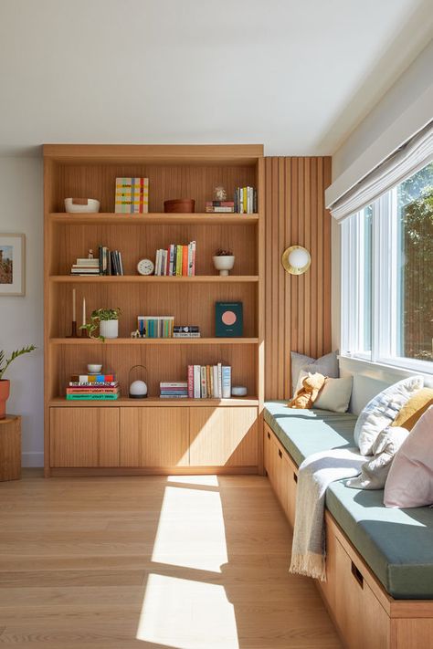 A custom oak shelf and bench transform an empty corner in this 70's-era home into a functional play/rest area for a young family with toddlers. Storage drawers beneath the bench holds children’s toys. A large window takes advantage of the expansive views from the house. (Photo by: Margaret Austin) Bench Drawer Storage, Wall Shelf Built In, Playful Living Room Decor, Mcm Built In Bookcase, Built In Storage Living Room, Home Library Corner, House Reading Nook, Built In Storage Wall, Built In Kitchen Bench