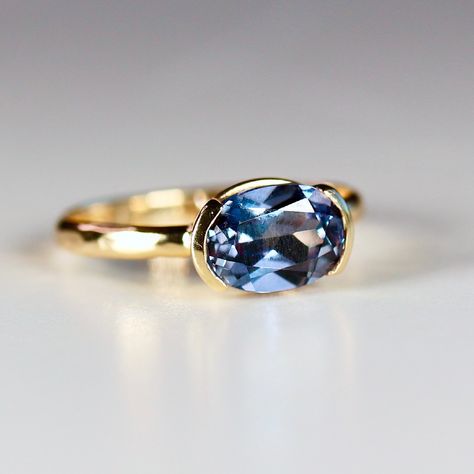 This beautiful oval lab grown color change sapphire ring was made of 8mmx6mm oval sapphire stone in 14k gold half bezel bezel setting and 14k yellow gold 2mm hammered band. It's perfect as a solitaire engagement ring or statement ring. DETAILS Ring Band: 14K YELLOW GOLDRing Band size: 2mm wide x 1mm thick half roundRing Band is hammered or smooth by requested.Gemstone: Lab grown color change sapphireGemstone size and cut: 6x8mm oval cutCarat weight : 1.25 ct. weightGemstone Quality : AAA *** All East West Oval Sapphire Ring, Half Bezel Sapphire Ring, Modern Sapphire Engagement Ring, Vintage Sapphire Engagement Rings Gold, Bezel Set Gemstone Ring, Bezel Set Sapphire Ring, Bezel Sapphire Ring, Bezel Sapphire Engagement Ring, East West Half Bezel