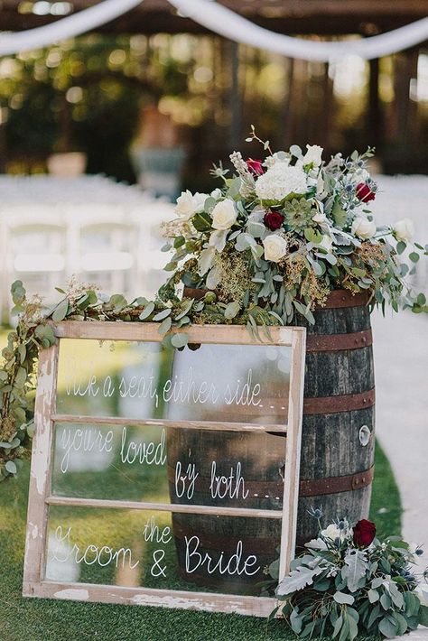 bohemian wedding decorations signs on old window frame near with wine barrel and red flowers kristen curette photography Wine Barrel Wedding Ideas, Wine Barrel Wedding Decor, Barrel Wedding Decor, Bohemian Wedding Reception, Wine Barrel Wedding, Boho Wedding Centerpieces, Wedding Window, Barrel Wedding, Boho Wedding Ceremony