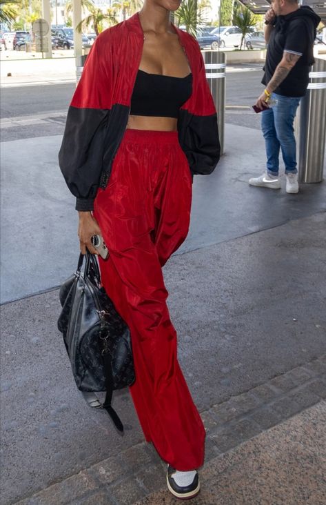 Red Airport Outfit, Red And Black Hip Hop Dance Outfits, Red Pants Outfit Black Women, Yellow Outfit Streetwear, Red Parachute Pants Outfit, Red Joggers Outfit For Women, Flame Clothes, Red Joggers Outfit, Red Sweatpants Outfit