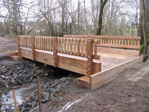 Timber Bridges Division | Vehicular & Pedestrian Bridges | Boardwalks | Western Wood Structures | Tualatin, OR Wooden Bridge Garden, Backyard Creek, Mountain Landscaping, Yard Bridge, Timber Bridge, Garden Bridge Design, Backyard Bridges, Outdoor Bridges, Bridge Ideas