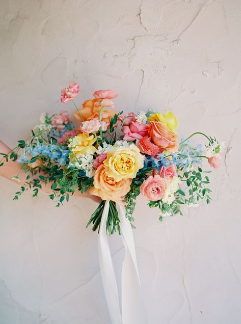 Photos by Stephanie Michelle Photography Peri & Nicholas’ summer wedding took place at Villa Antonia— just outside of Austin, Texas. Their pastel flowers featured a rainbow of colors: shades of pink, pops of yellow, notes of blue and warm touches of coral. Peri’s bridal bouquet was a brilliant arrangement of vibrant blooms that felt elegant but whimsical. Rainbow Wedding Flowers, Rainbow Bouquet, Flowers Poppy, Colorful Bridal Bouquet, Small Wedding Bouquets, Bridal Bouquet Summer, Bridal Bouquet Spring, Bridal Bouquet Blue, Pastel Wedding Flowers