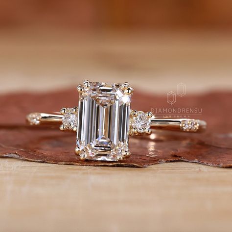 "Discover a lifetime of love with our Three Stone Engagement Ring, a blend of timeless elegance and modern design. This Lab Grown Diamond Engagement Ring, handmade by Diamondrensu, is a conversation starter. Each IGI Certified Emerald Cut Ring for Women is crafted for enduring allure, making it the perfect Anniversary Gift or a Promise Ring for her. Our meticulous craftsmanship ensures a beautiful, ethical choice for your significant moments. Choose Diamondrensu, where every ring is a promise of Classic Rose Gold Emerald Ring For Anniversary, Radiant Cut Rose Gold Ring For Anniversary, Rose Gold Radiant Cut Ring For Anniversary, Rose Gold Emerald Cut Diamond Ring For Anniversary, Three Stone Emerald Cut Ring, Stone Ring Design, Diamond Centerpiece, Emerald Cut Ring, Moissanite Vs Diamond