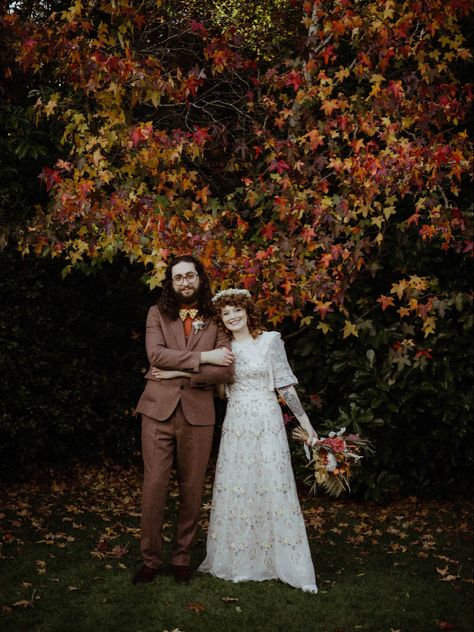 Late october autumn wedding in Surrey, UK. Bride’s dress by Needle and Thread. Groom’s suit by Gianni Feraud. Photo by devlinphotos Flowers by thedriedflowercollection21 Makeup by makeup_by_millierose Curls crafted by spookyruno #autumnwedding #fallwedding #rocknrollbridemagazine #rockmywedding #alternativebride #curlyhair #curlyshag #bohowedding #weddingonabudget Late Fall Wedding, Late Summer Wedding, Rock N Roll Bride Magazine, Autumn Wedding Decor, Needle And Thread Dresses, October Flowers, Late Summer Weddings, British Summer, Autumn Bride