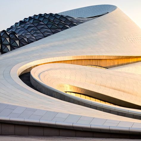 Designed by MAD Architects, the Harbin Opera House in northern China features a sculptural lobby with timber-clad balconies and stairs. Harbin Opera House, Harbin China, Mad Architects, Rem Koolhaas, Parametric Architecture, Harbin, Organic Architecture, Zaha Hadid, Futurism