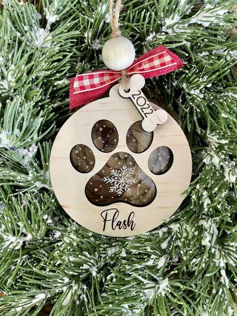 This cute ornament is perfect for your puppy's first Christmas! Animals love to be included in the holiday season, so why not give them their own special personalized ornament!

-Ornament size is 3 1/2 in round
-Laser Engraved for lasting durability
-Ornament is cut from real wood, so the color may vary Laser Wood Ornaments, Laser Cut Christmas Ornaments, Diy Wood Plans, Paw Print Ornament, Animals Love, Holiday Crafts Diy, Puppy Paws, Christmas Puppy, Dog Christmas