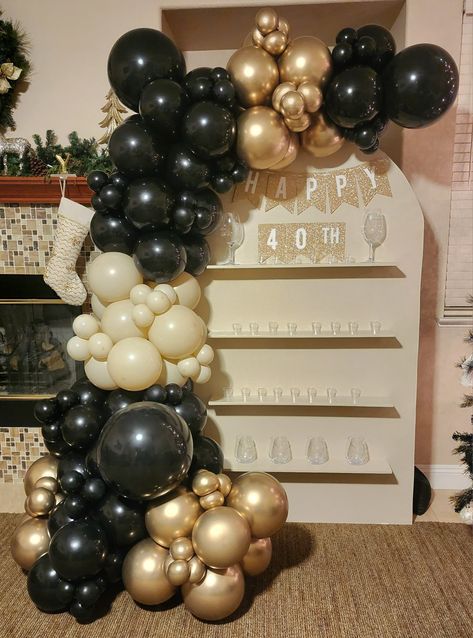 40th Birthday Champagne wall backdrop, shot glass panel, balloon garland Black Gold Champagne Balloons, Champagne Wall Balloon Garland, Black Gold And Cream Balloon Garland, Champagne Wall With Balloons, Champagne Backdrop, Black Gold Balloon Garland, Black Balloon Garland, Gold Balloons Decorations, 50th Birthday Party Ideas For Men