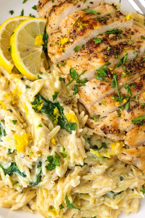 Lemon Chicken Orzo! This creamy one pot lemon chicken orzo is perfect for weeknights, and an amazing comfort food recipe. The orzo is tender, and it's tossed with fresh lemon and spinach. Greek Chicken And Lemon Rice One Pot, One Pan Lemon Chicken And Orzo, Lemon Orzo With Chicken, Orzo Chicken Thigh Recipes, Lemon Chicken Orzo Crockpot Recipes, Lemon Chicken Orzo Bake Boursin, Chicken Orzo Instant Pot Recipes, Sides For Lemon Chicken, Greek Chicken Orzo Bake