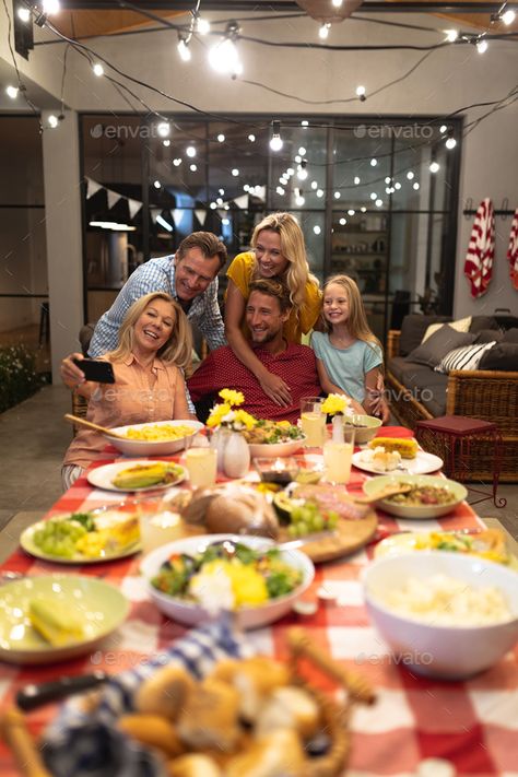 Multi-generation Caucasian family during a dinner and taking a selfie by Wavebreakmedia. Multi-generation Caucasian family enjoying their time at home together, sitting by a table, putting food their plates... #Sponsored #dinner, #selfie, #Wavebreakmedia, #family Family Eating At Restaurant, Dinner Selfie, Family Lunch, Family Meeting, Taking A Selfie, Home Together, Eat Together, Family Eating, Kitchen Concepts