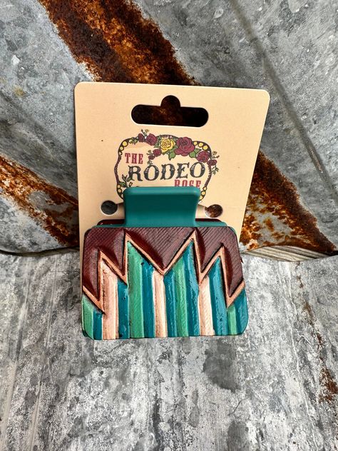 Introducing our captivating Small Southwest Hand-Tooled Hair Clip, a stylish accessory measuring 2 inches by 2 inches, meticulously crafted at The Rodeo Rose shop nestled in the heart of South Dakota's scenic Black Hills. This stunning hair clip features an intricate Southwest-inspired pattern, hand-tooled with expert precision. Each leather patch is individually hand-dyed and hand-painted to perfectly match the hair clip, ensuring a harmonious and eye-catching design. Crafted with care and atte Small Hair Clips, Leather Blazer Jacket, Rose Shop, Leather Art, Black Hills, Leather Projects, Leather Work, Light Turquoise, Tooled Leather