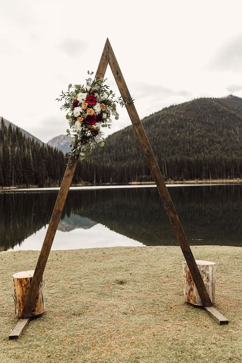 Wooden triangle A-frame wedding arch for ceremony and reception backdropwith floral bouquet. Wedding Arch Decoration Ideas, Arch Decoration Ideas, Wooden Wedding Arch, Simple Wedding Arch, Wooden Wedding Arches, Wedding Aisle Outdoor, Wedding Arbors, Photobooth Ideas, Reception Backdrop