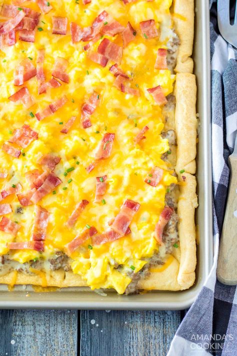 Sheet pan breakfast pizza is loaded with melty cheese, eggs, bacon, and a tasty sausage gravy all on top of a crescent dough crust. It's a savory breakfast wonder that fills bellies with happiness. Pizza With Crescent Rolls, Make With Crescent Rolls, Easy Biscuits And Gravy, Sheet Pan Breakfast, Casserole Bake, Crescent Dough Sheet, Crescent Roll Pizza, Scrambled Eggs With Cheese, Breakfast Pizza Recipe