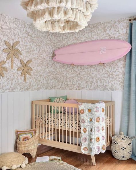 Cute girly baby nursery with a pink surf board Beachy Themed Nursery, Pink Palm Nursery, Beach Inspired Nursery, Pink Beach Nursery, Boho Beach Nursery Girl, Pink Coastal Nursery, Ocean Theme Nursery Girl, Beach Nursery Girl, Unique Girl Nursery